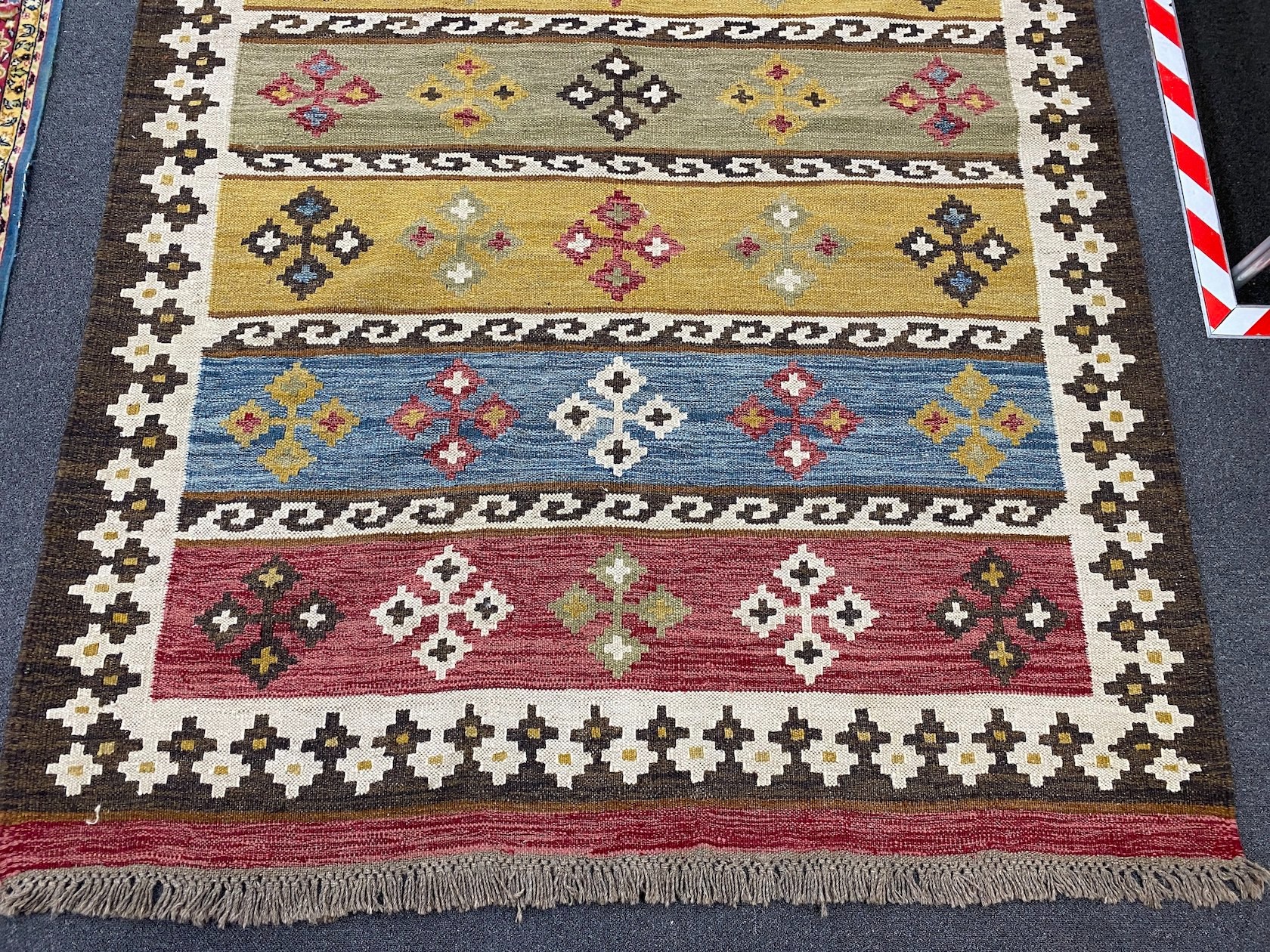 A Kilim polychrome flat weave carpet, 240 x 170cm